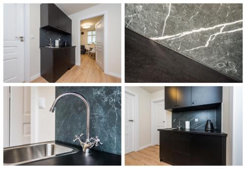 Una cocina con fregadero y encimera negra. en Pearl of Sopot, en Sopot