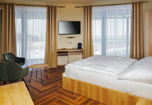 Postel nebo postele na pokoji v ubytování Hotel Dymník