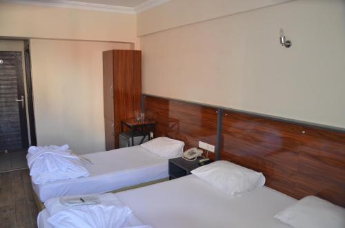 a room with three beds in a room at Marka Hotel in Antalya
