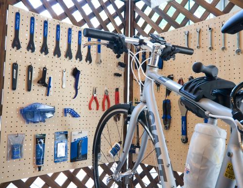 a bicycle is parked in a garage with knives andrenches at 汐の丸 in Imabari