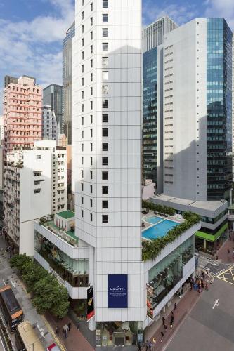 an aerial view of a tall white building with a pool at Novotel Century Hong Kong in Hong Kong