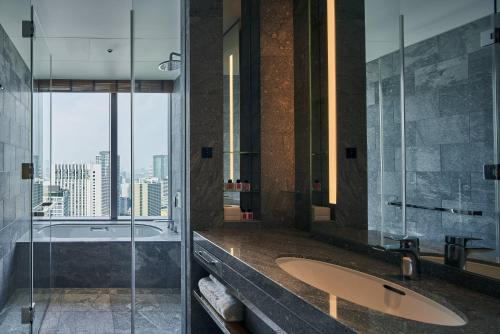 a bathroom with two sinks and a glass shower at The Okura Tokyo in Tokyo