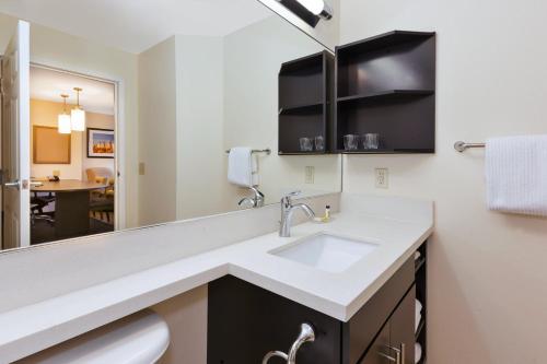 a bathroom with a sink and a mirror at Candlewood Suites Polaris, an IHG Hotel in Columbus
