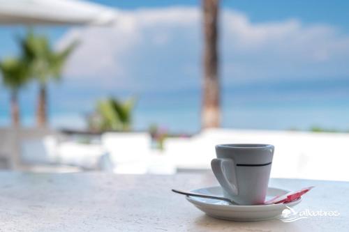 a coffee cup sitting on a plate on a table at Residence Albatros in Briatico