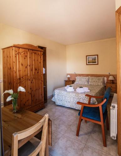 a hotel room with a bed and a table and a table sidx sidx at Apartamentos Maribel in Calaceite