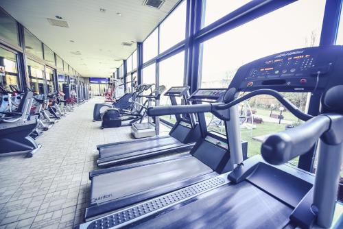 a gym with rows of tread machines in a building at Hotel Spa Ice Resort in Timişoara