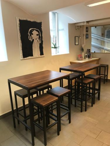 a row of tables and stools in a room at Hostel Dalagatan in Stockholm