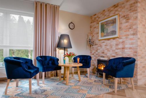 a living room with a table and chairs and a brick wall at Plaża Resort in Morąg