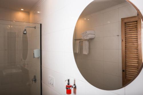 a bathroom with a mirror and a shower at Redcon Suites in Hurghada