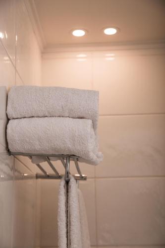 a towel rack with towels on it in a bathroom at Redcon Suites in Hurghada