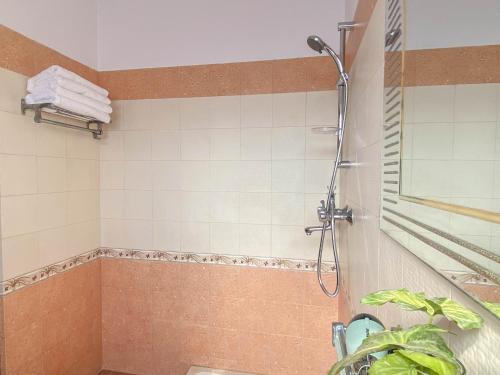 a bathroom with a shower with a plant in it at Kibu Home in Kathmandu