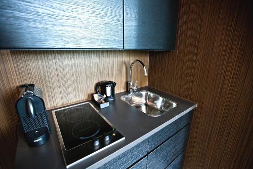 a kitchen counter with a sink and a coffee pot at V Lofts in Amsterdam