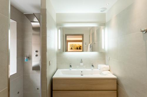 a bathroom with a sink and a mirror at Les chambres du domaine in Eguisheim