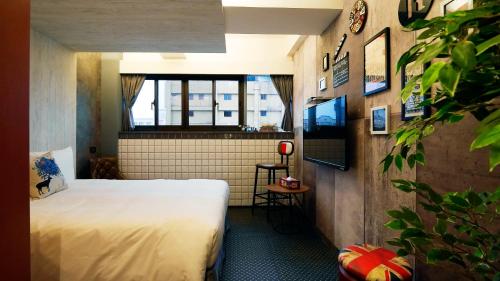 a hotel room with a bed and a window at K Hotel - Yizhong in Taichung