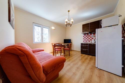 a living room with a chair and a refrigerator at Apartments Pelle in Tivat