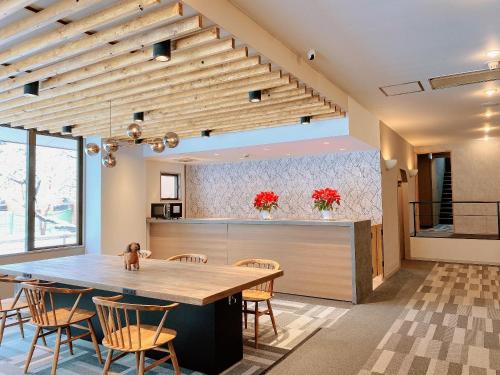 - une salle à manger et une cuisine avec une table et des chaises dans l'établissement Sora Hotel Karuizawa Outlet, à Karuizawa