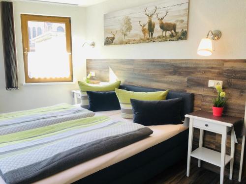 a bedroom with two beds and a wooden headboard at Pension "Tor zum Rennsteig" in Hörschel