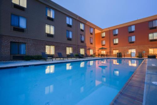 a swimming pool in front of a building at Holiday Inn Express Charles Town, an IHG Hotel in Shenandoah Junction