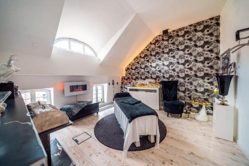 a bedroom with a stone wall with a fireplace at Hotel Suitess in Dresden