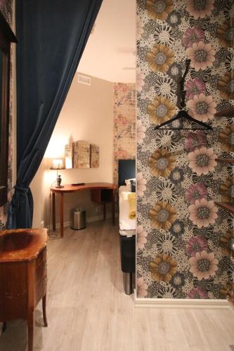a room with a wall with flowers on it at Skanstulls Boutique Hostel in Stockholm