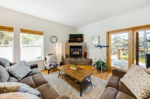 a living room with couches and a fireplace at Yaquina Lighthouse View Beach Home in Newport