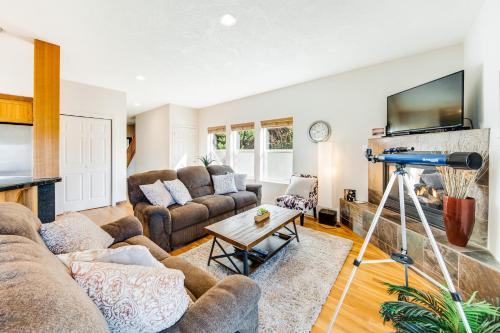 a living room with two couches and a fireplace at Yaquina Lighthouse View Beach Home in Newport