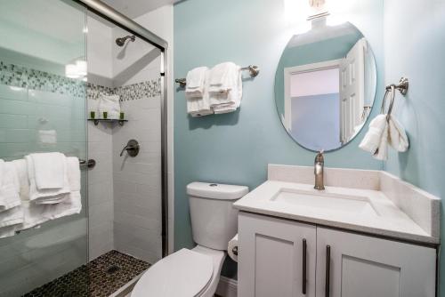 a bathroom with a toilet and a sink and a mirror at Rainbow Bend Resort in Marathon