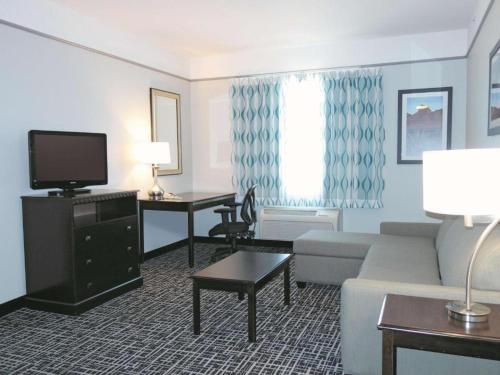 a living room with a couch and a tv at La Quinta by Wyndham Dumas in Dumas