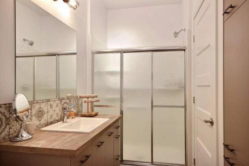 a bathroom with a sink and a shower at The Shack by BnbCopilote in Quebec City