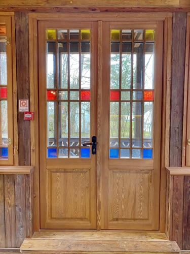 a pair of doors with stained glass windows at Villa Gaida in Saulkrasti