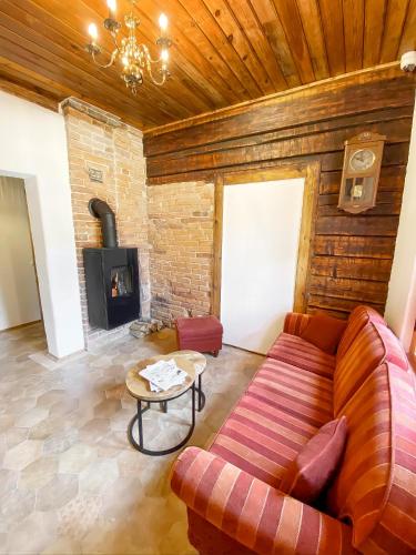 a living room with a couch and a fireplace at Villa Gaida in Saulkrasti