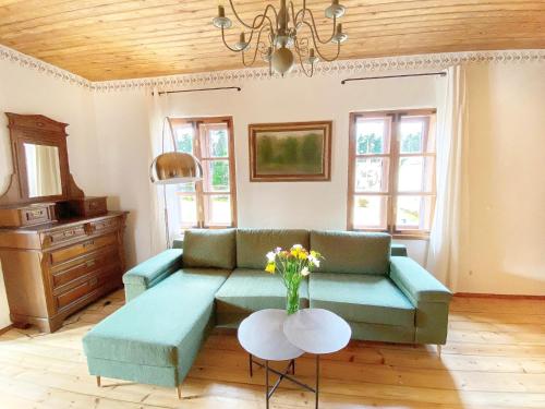 a living room with a couch and a table at Villa Gaida in Saulkrasti