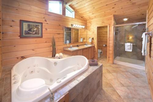 a large bathroom with a tub and a shower at The Lodges at Cresthaven in Lake George