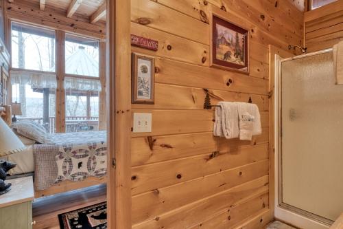a log cabin bathroom with a shower and a mirror at Amazing Grace #25 in Sevierville