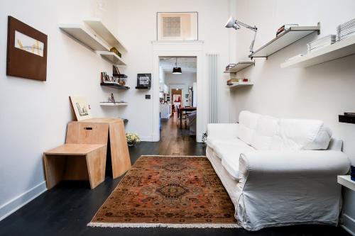 a living room with a white couch and a rug at Mars41 B&B in Bologna