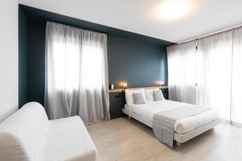 a bedroom with two beds and two windows at Attico43 B&B in Florence