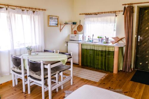 a kitchen with a table and a counter top at Rosma Mill Holiday House in Põlva