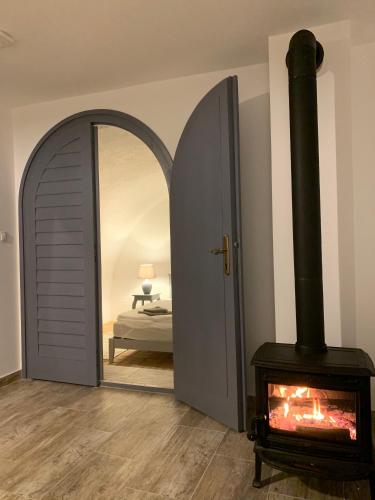 a living room with a fireplace and a mirror at Hillside Apartments in Révfülöp