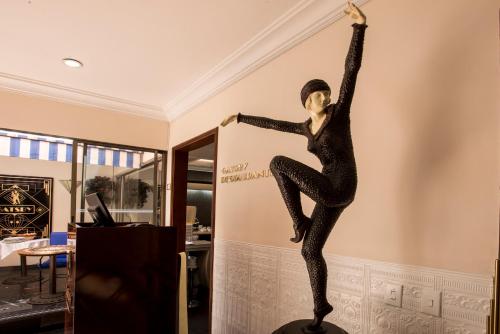 a statue of a woman dancing on a wall at Lancaster House in Bogotá