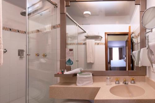a bathroom with a sink and a shower at Lancaster House in Bogotá