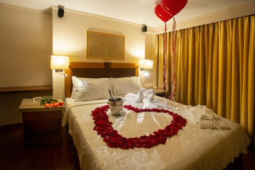 a bed with a heart made out of roses at Lancaster House in Bogotá
