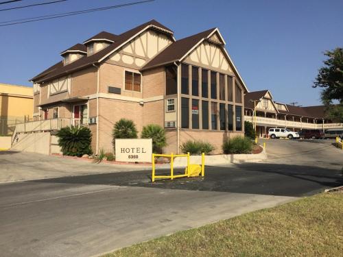 a hospital building with a yellow sign in front of it at Star Inn Hotel in San Antonio