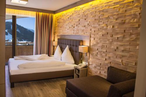 Säng eller sängar i ett rum på Hotel am Reiterkogel