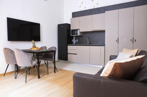 a living room filled with furniture and a tv at Apartments More in Dubrovnik