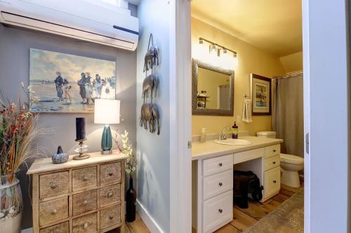 a bathroom with a sink and a toilet and a mirror at Broad Street Inn in Nevada City