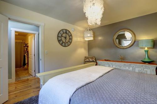 a bedroom with a bed and a clock on the wall at Broad Street Inn in Nevada City