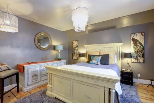 a bedroom with a white bed and a mirror at Broad Street Inn in Nevada City