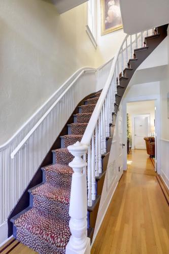 a staircase in a home with a white stair case at Broad Street Inn in Nevada City