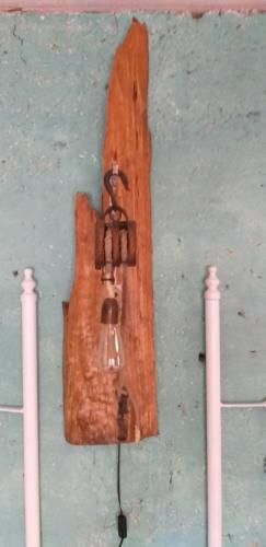 a light hanging on a wall with two candles at Cabañas El Desván in Puente Negro