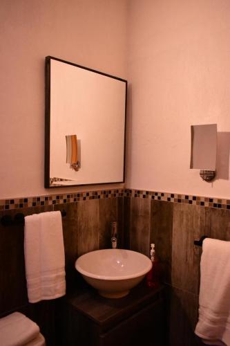 a bathroom with a sink and a mirror at Casa Bravía - Hotel·RV in San Luis Soyatlán